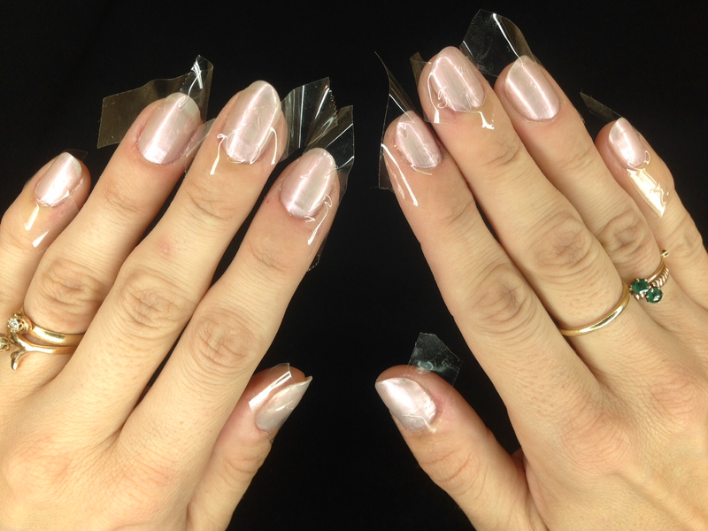 Step 2: When your base color is dry, cover half of each nail with Scotch tape in a haphazard-to-painstakingly-specific fashion, depending on the severity of your particular anxiety disorder. Starting from my left pinky, I chose to cover the lower left quadrant of the nail, then the upper right quadrant of my ring fingernail, then the lower right quadrant of my middle nail, and so on. I taped my left hand first and then tried to mirror the direction of the tape on my right hand. But honestly, you could just slap tape wherever and it’ll still be fine and you’ll probably live a happier life.